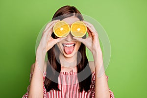 Closeup portrait photo of pretty funky young girl hold two oranges eyeglasses stick out tongue healthy weekend wear