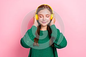 Closeup portrait photo of young dreamy relaxed girl closed eyes listening music jazz chilling pause break hold earphones