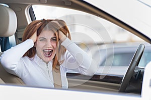 Closeup portrait of pissed off displeased angry aggressive woman driving a car shouting at someone. Negative human expression