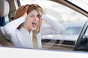 Closeup portrait of pissed off displeased angry aggressive woman driving a car shouting at someone. Negative human expression