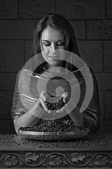 Closeup portrait of pretty girl hold hot roasted coffee beans in