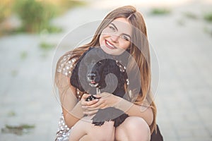 Closeup portrait of pretty young teen girl with black cocker spaniel dog