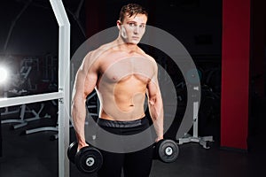 Closeup portrait of professional bodybuilder workout with barbell at gym. Confident muscular man training . Looking