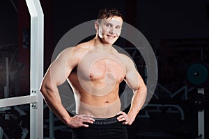 Closeup portrait of professional bodybuilder workout with barbell at gym. Confident muscular man training . Looking