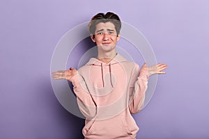 Closeup portrait of puzzled clueless young man shrugging his shoulders