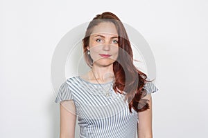 Closeup portrait of a red-haired woman isolated over white background