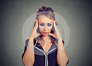 Closeup portrait sad young woman with worried stressed face expression looking down