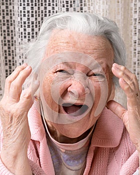 Closeup portrait of scared old woman