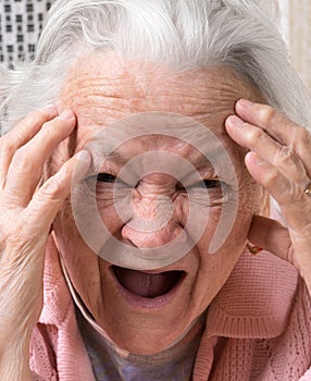 Closeup portrait of scared old woman
