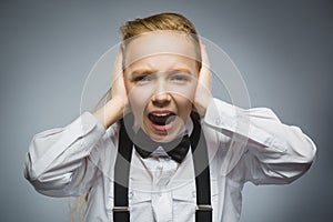 Closeup portrait of screaming girl covering her ears, observing. Hear nothing. Human emotions, facial expressions