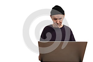 Closeup portrait senior, elderly, mature, man in black hat and t-shirt trying to figure out how use laptop internet