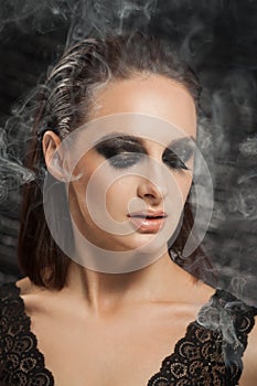 Closeup portrait of a serious lady with smoky eye makeup