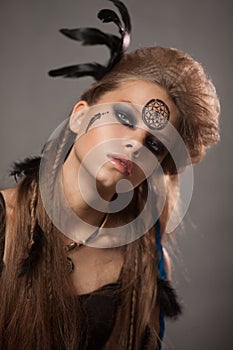 Closeup portrait of shamanic female with colorful makeup.