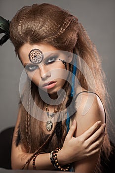 Closeup portrait of shamanic female with colorful makeup.