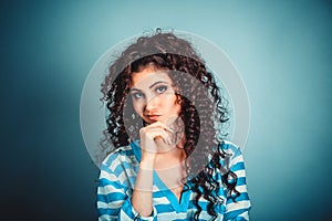 Closeup portrait of skeptical young lady, curly woman