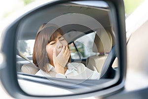 Closeup portrait sleepy, tired young woman driving her car after