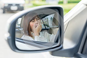 Closeup portrait sleepy, tired young woman driving her car after