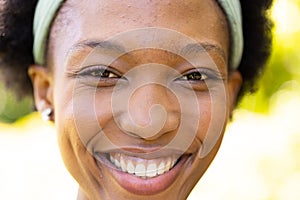 Closeup portrait of smiling african american mid adult woman in park