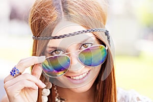 Closeup portrait of smiling beautiful hippie woman looking over