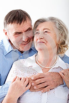 Closeup portrait of smiling elderly couple