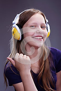 Closeup portrait of a smiling teen girl with headphones