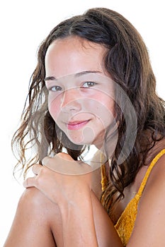 Closeup portrait of smiling teen girl posing over white background