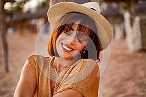 Closeup portrait of smiling young latino woman at the beach