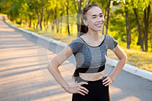 Closeup portrait of sporty athletic woman in sportswear smiling in camera.