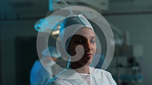 Closeup portrait of successful African female doctor in surgical uniform standing posing looking at camera in operation