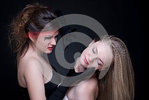 Closeup portrait of two girls: good & evil