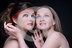 Closeup portrait of two girls: good & evil
