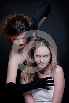 Closeup portrait of two girls: good & evil