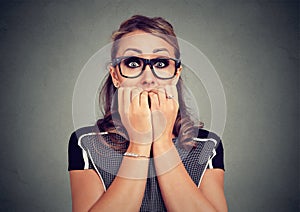 Closeup portrait unsure hesitant anxious woman biting her fingernails