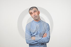 Closeup portrait of a upset worried sad, depressed, tired man isolated on gray background.