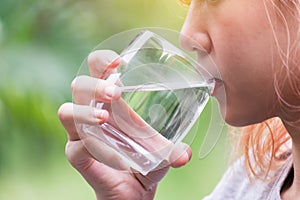 Closeup portrait woman drinking water bottle in nature refresh for her live