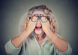 Closeup portrait woman in glasses covering face eyes with both hands