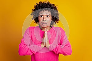 Closeup portrait woman worried face plead gesture isolated yellow wall background photo