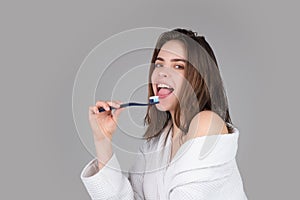 Closeup portrait of womans toothy smile against a  background with copy space. Girl brushing her teeth