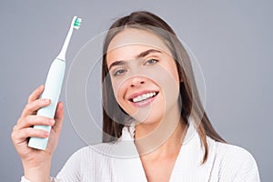 Closeup portrait of womans toothy smile against a isolated background with copy space. Girl brushing her teeth