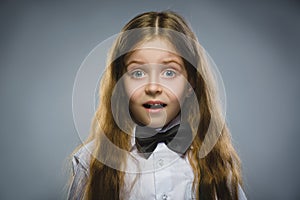 Closeup Portrait of wondering girl going surprise on gray background