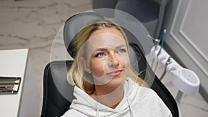 Closeup portrait of worried frighten scared female patient lying in medical chair in dental office before treatment in
