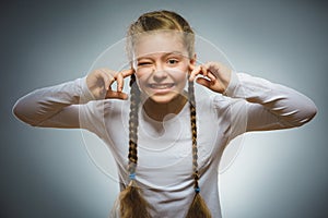 Closeup portrait of worried girl covering her ears, observing. Hear nothing