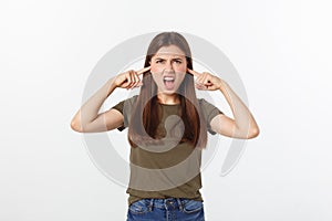 Closeup portrait of a young angry woman covering her ears, stop making that loud noise it`s giving me a headache