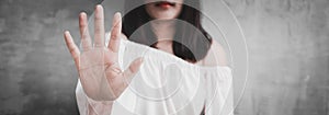 Closeup portrait young annoyed angry woman with bad attitude giving talk to hand gesture with palm outward isolated grey wall.