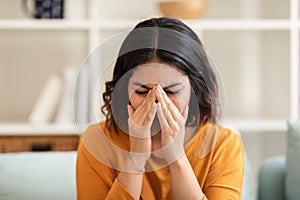 Closeup Portrait Of Young Arab Woman Crying At Home