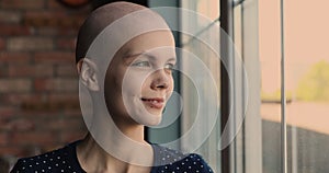 Closeup portrait of young bald optimistic female cancer patient