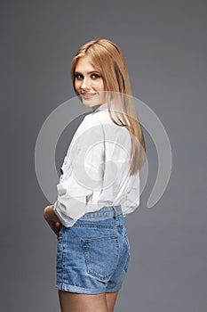 Closeup portrait of a young beautiful blonde woman in a white shirt