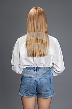 Closeup portrait of a young beautiful blonde woman in a white shirt