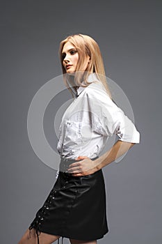 Closeup portrait of a young beautiful blonde woman in a white shirt