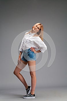 Closeup portrait of a young beautiful blonde woman in a white shirt